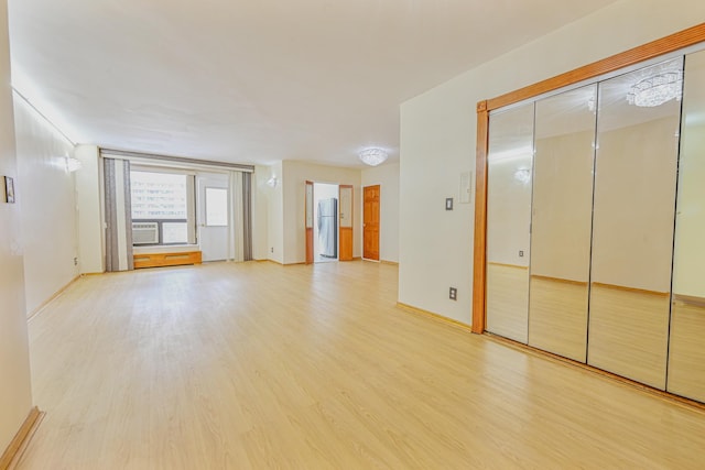 empty room with light hardwood / wood-style floors