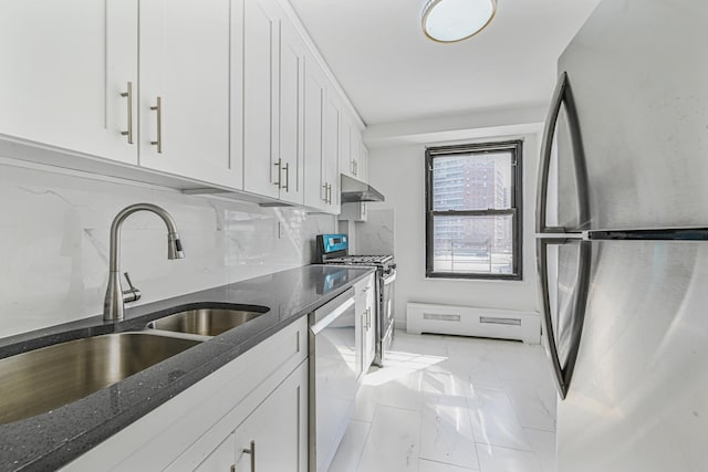 kitchen with sink, white cabinetry, appliances with stainless steel finishes, dark stone counters, and backsplash