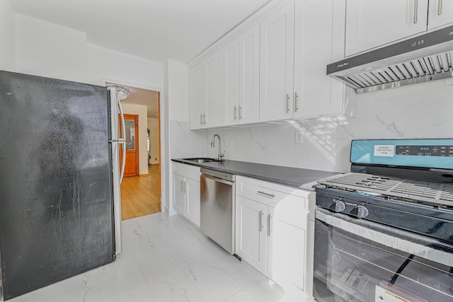 kitchen with white cabinetry, stainless steel appliances, sink, and tasteful backsplash