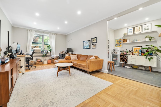 living room with ornamental molding and light parquet floors