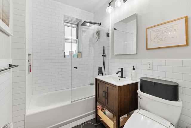 full bathroom with tiled shower / bath combo, vanity, tile walls, and toilet