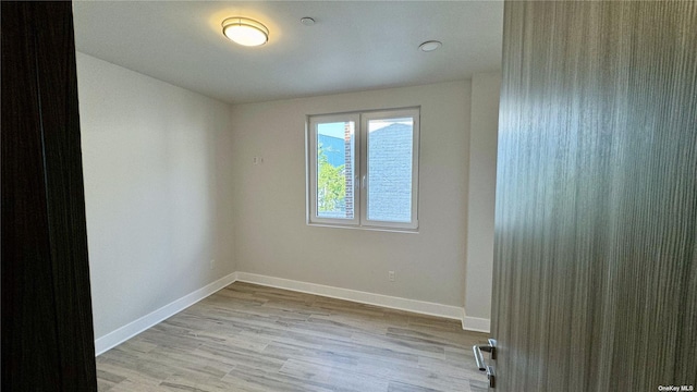 spare room with light hardwood / wood-style flooring