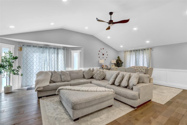 living room with hardwood / wood-style floors, vaulted ceiling, and ceiling fan