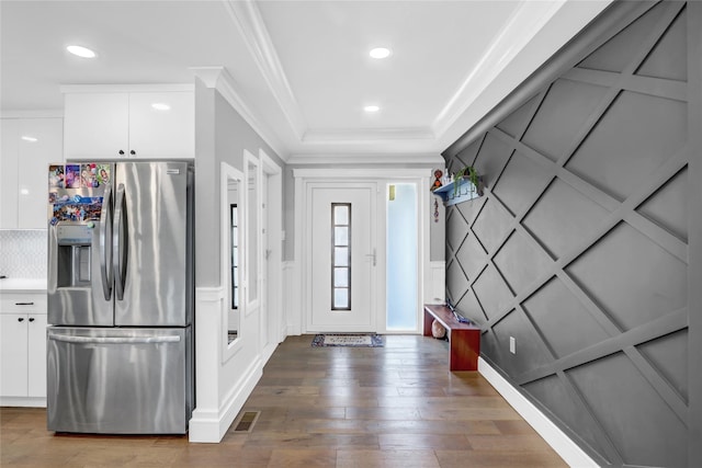 entryway featuring hardwood / wood-style flooring and crown molding