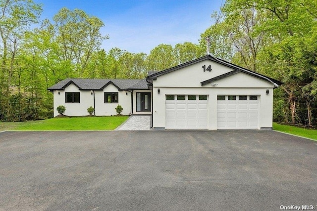 ranch-style house featuring a garage and a front yard