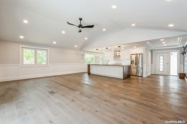 interior space with vaulted ceiling, light hardwood / wood-style flooring, and a wealth of natural light