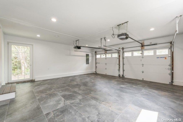 garage with a garage door opener and electric panel