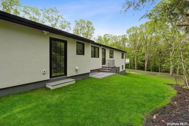 rear view of house featuring a lawn