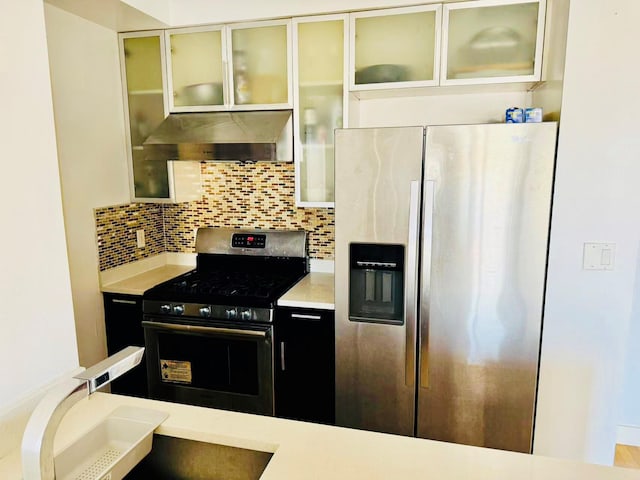 kitchen with tasteful backsplash, sink, and appliances with stainless steel finishes