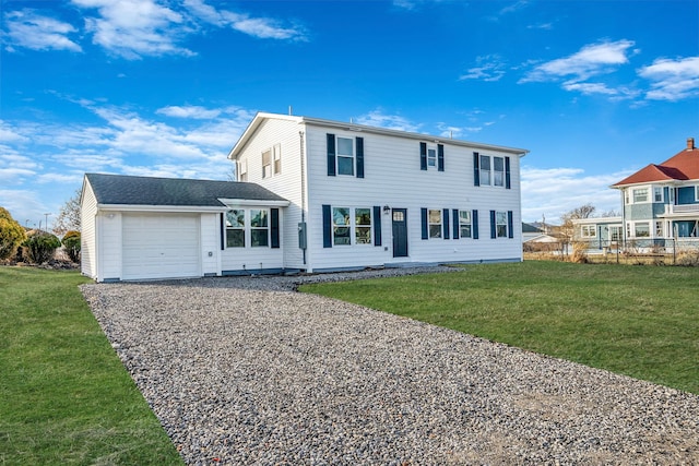 view of front of house with a garage and a front yard