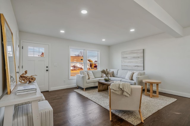 living room with beam ceiling and dark wood-type flooring