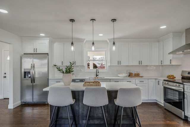 kitchen featuring pendant lighting, white cabinetry, and stainless steel appliances