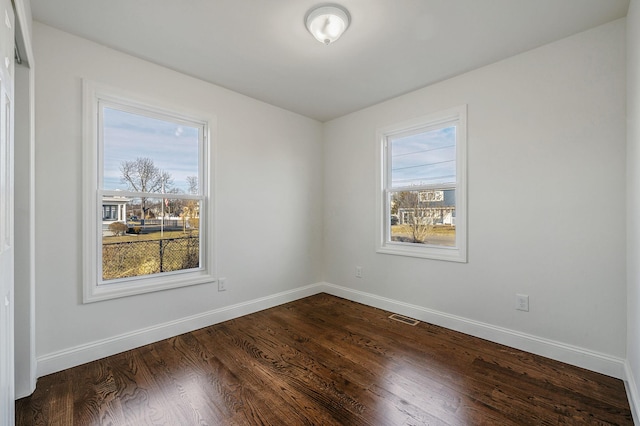 spare room featuring dark hardwood / wood-style flooring