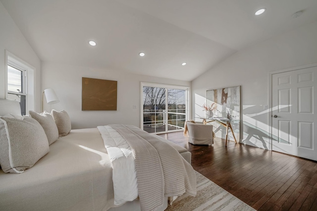 bedroom featuring hardwood / wood-style flooring, vaulted ceiling, access to exterior, and multiple windows