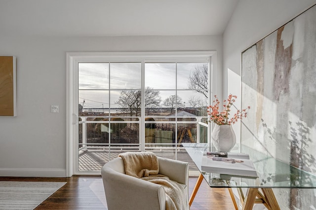 interior space featuring hardwood / wood-style flooring and vaulted ceiling