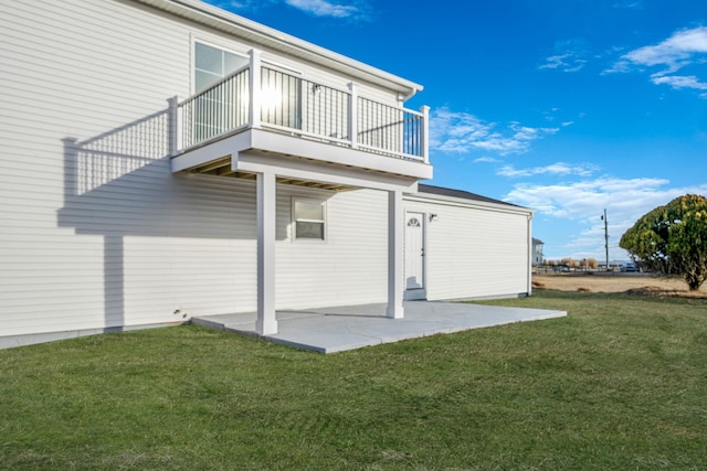 exterior space with a patio, a balcony, and a yard