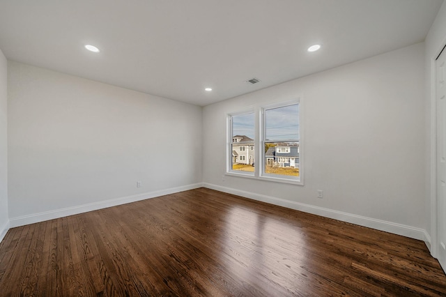 spare room with dark hardwood / wood-style floors