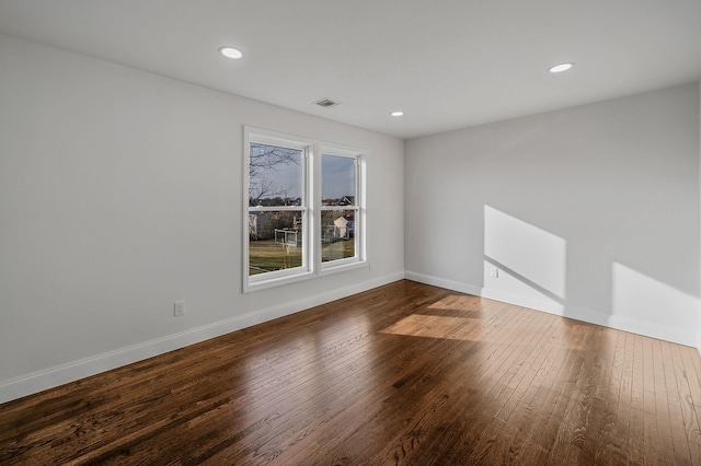 unfurnished room with wood-type flooring