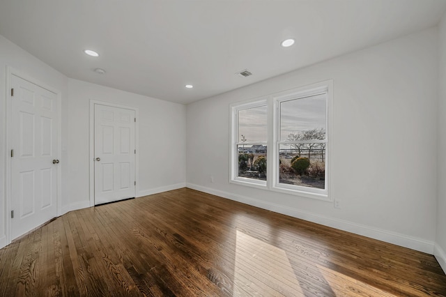 empty room with hardwood / wood-style flooring