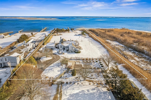 snowy aerial view with a water view