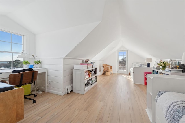 office area with vaulted ceiling and light wood-type flooring