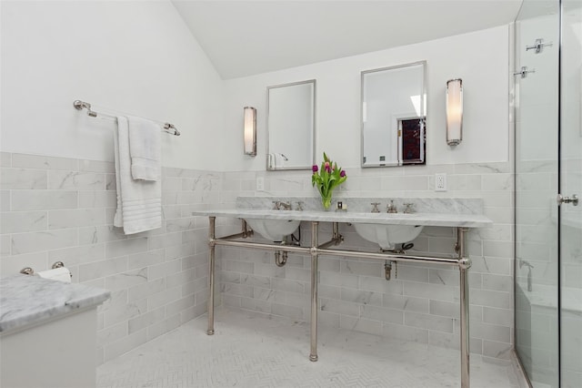 bathroom with tile walls and double sink