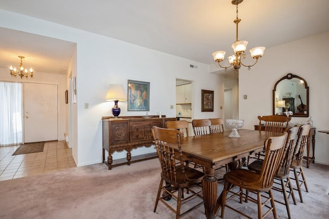 dining area featuring light tile patterned floors, visible vents, baseboards, light colored carpet, and a chandelier