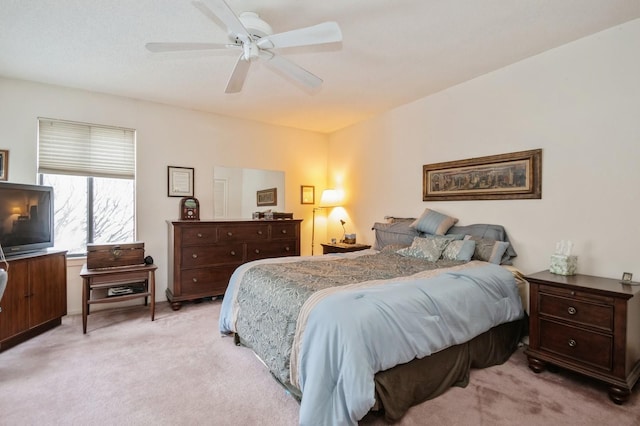 bedroom featuring light carpet and ceiling fan