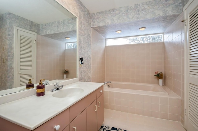 bathroom featuring a garden tub, wallpapered walls, a closet, and vanity