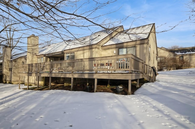 snow covered property featuring a deck