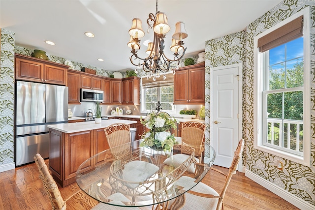 dining area featuring wallpapered walls, baseboards, a chandelier, and light wood-style flooring