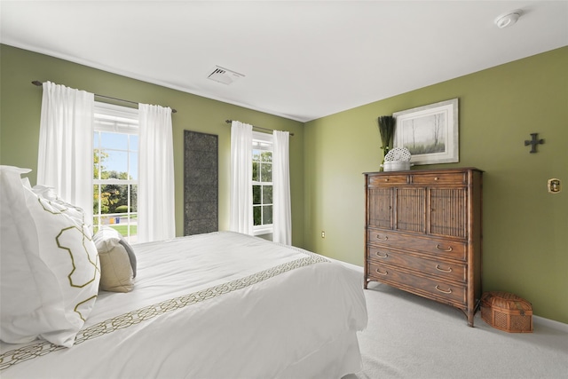 carpeted bedroom featuring visible vents and baseboards