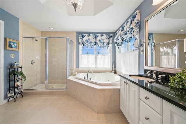 full bath featuring a stall shower, tile patterned flooring, vanity, and a bath