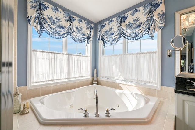 bathroom with a tub with jets and vanity