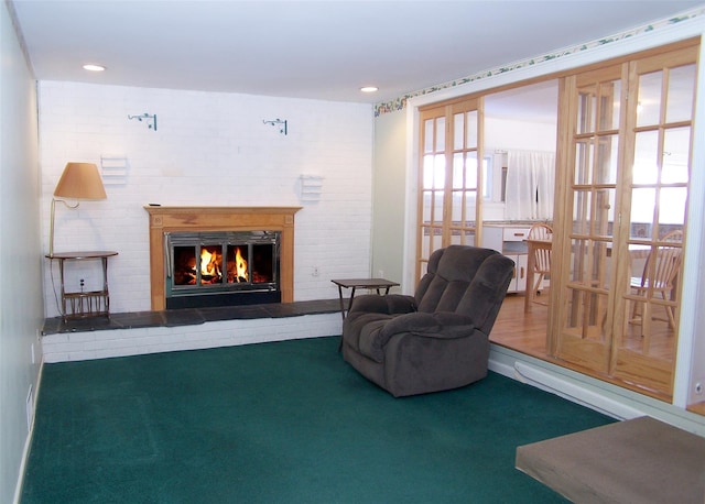 sitting room featuring a brick fireplace and carpet flooring