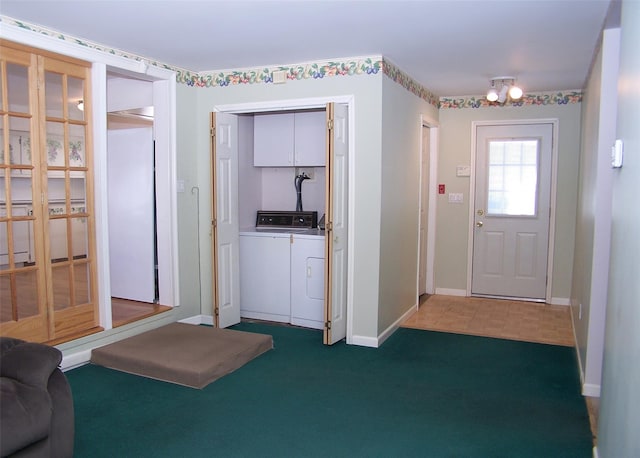 carpeted foyer entrance with washer and dryer