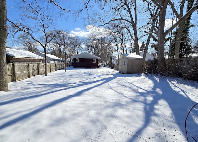 snowy yard with a shed