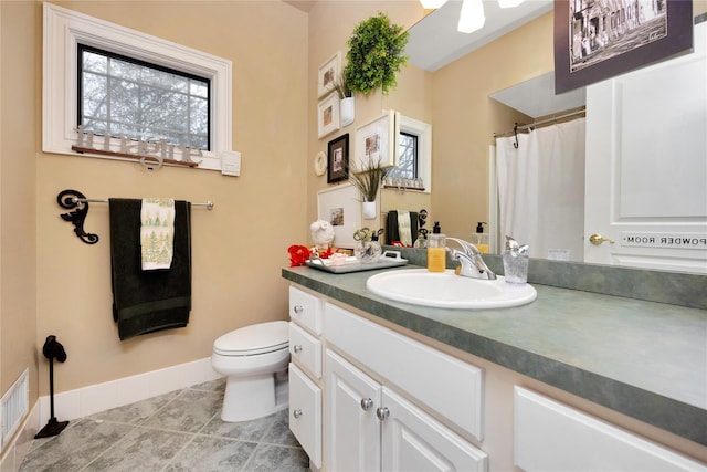 bathroom with vanity, tile patterned flooring, and toilet