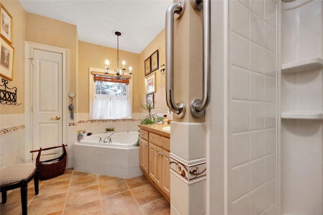 bathroom featuring tiled bath, tile walls, tile patterned flooring, vanity, and an inviting chandelier