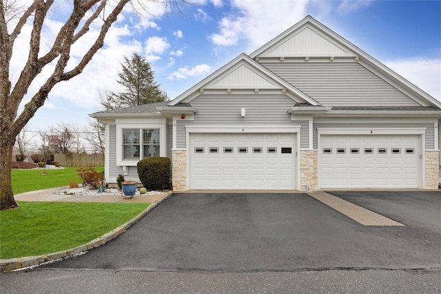 view of front of house with a garage and a front lawn