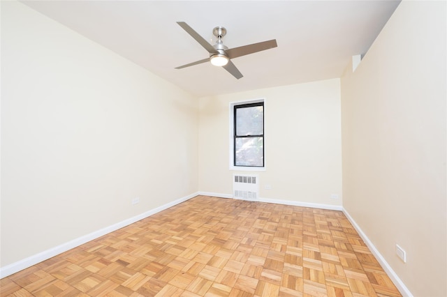 empty room featuring ceiling fan and light parquet floors