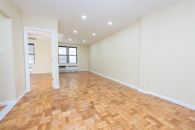 empty room with radiator and light parquet floors