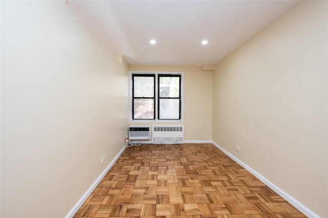 empty room with radiator heating unit, heating unit, and light parquet floors