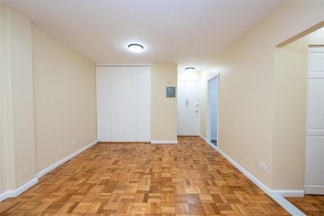 unfurnished bedroom featuring a closet and light parquet floors