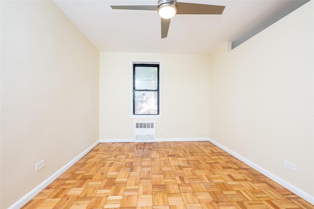 empty room with ceiling fan and light parquet floors