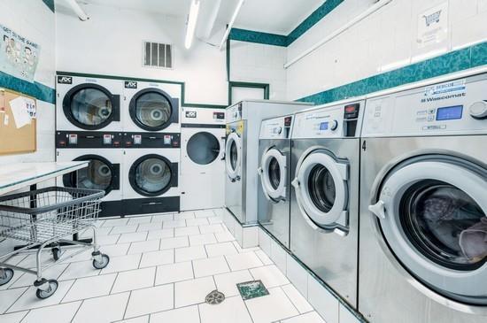 washroom with separate washer and dryer, stacked washer and clothes dryer, and light tile patterned flooring