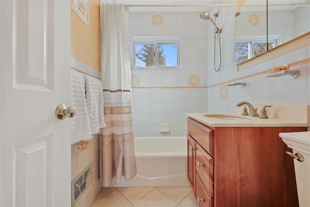 bathroom featuring tasteful backsplash, tile walls, vanity, shower / bath combo, and tile patterned floors