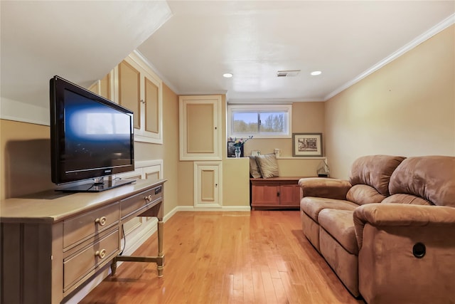 living room featuring ornamental molding and light wood-type flooring