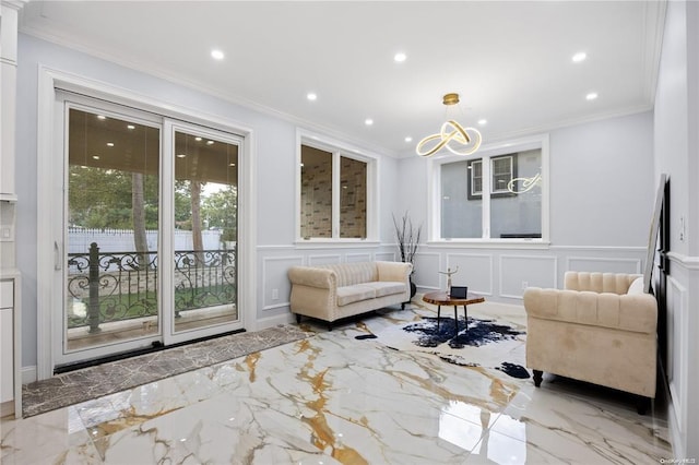 living room with ornamental molding and a chandelier