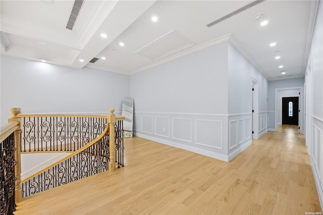 corridor featuring ornamental molding and light hardwood / wood-style floors